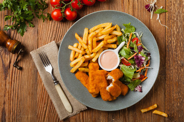 Fish sticks with fries and salad.