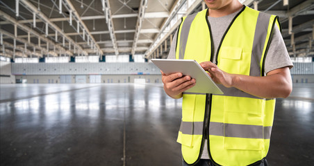 worker hand holding pad for check order pick time in empty warehouse © MyCreative