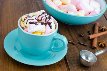 Hot chocolate in blue cup with marshmallows