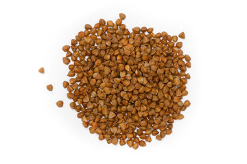 Buckwheat grains scattered on a white background