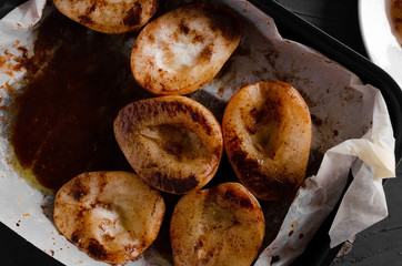 Caramelized Pears - Poached pears with spices in syrup on the white plate