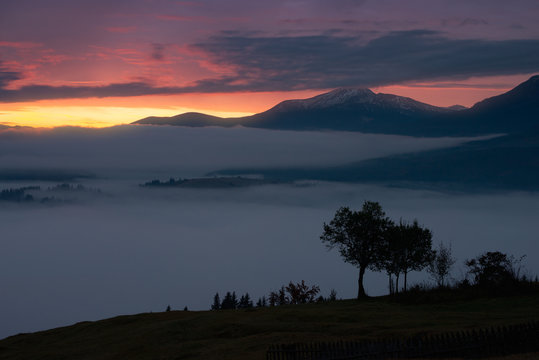 Sunrise in foggy mountains