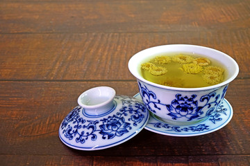 Chrysanthemum tea. Chinese tradition chrysanthemum tea in beautiful blue and white porcelain cup, famous herbal tea from Huangshan , Anhui China. Selective focus, copy space.