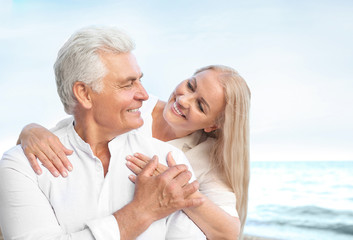 Happy mature couple at sea resort