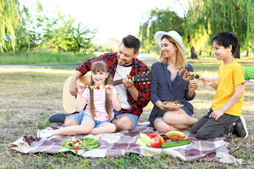 Happy family having picnic on summer day