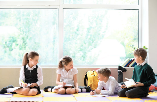 Cute little children doing lessons in classroom