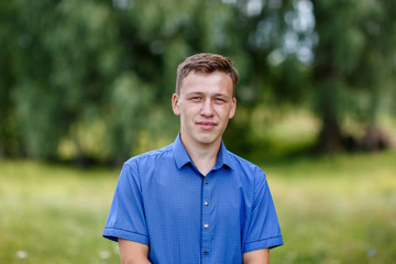 the guy in the blue shirt outdoors on a summer day