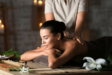 Beautiful young woman receiving massage in spa salon - obrazy, fototapety, plakaty