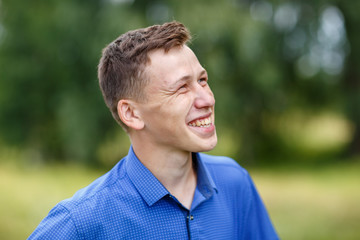 the guy in the blue shirt outdoors on a summer day