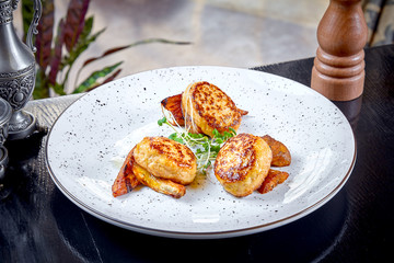 Modern cuisine. Close up view on reastaurant serving cutlet from rabbit on grilled carrot with micro green on white plate. Healthy food concept. Grilled meat. burger. Flat lay