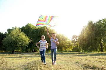 Children flying kite on summer day