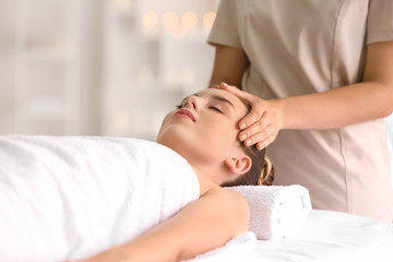 Fototapeta na wymiar Young woman having massage in spa salon