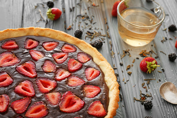 Tasty chocolate cake with strawberry on table, closeup