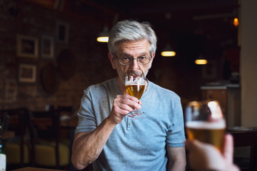 Pensive man with a beer in a bar