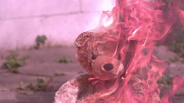 Burning Teddy bear in slow motion