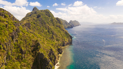 Seascape with tropical islands. El Nido Palawan National Park Philippines. Rocky islands covered with forest. Small lagoons with white beaches. Boat tours between the islands.