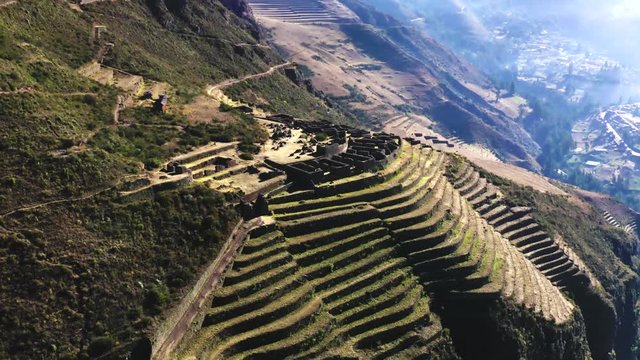 Aerial view of the ancient Inca ruins of Pisac (Pisaq) in the Sacred Valley near Cusco, Peru. Archaeological park with green terraces.