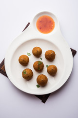 Crispy Veg lollipop recipe made using boiled potato with spices covered with corn flour and bread crumbs coating and then deep fried, served with toothpick or ice cream stock inserted in it with sauce