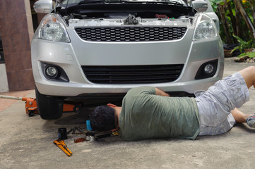 Car mechanic loosen oil filter