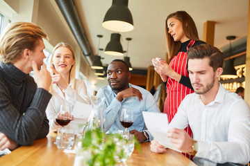 Waitress is waiting for the order of young people