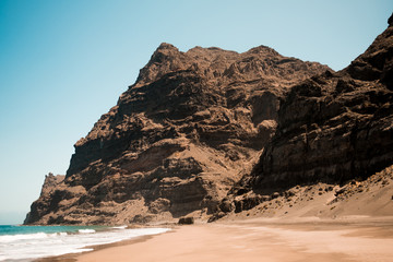 scenic view of gui gui beach in gran canaria island in spain with spectacular mountains landscape...