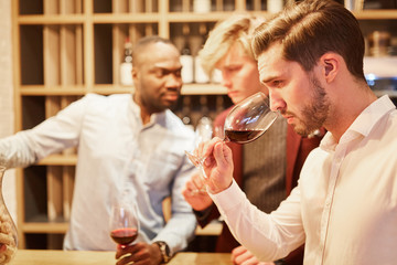 Young man with friends at a wine tasting