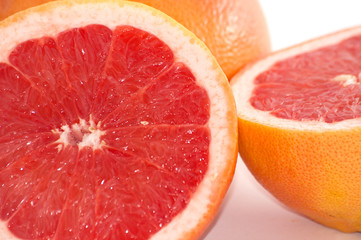 Slices of grapefruit macro closeup on white background