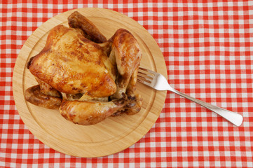 Grilled chicken on cutting board on tablecloth background © Valerii Evlakhov