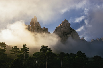 Jagged mountain peaks above a green forest