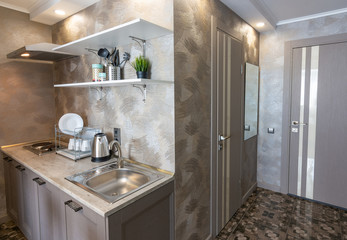 The corner of the small kitchen and the entrance to the hotel room