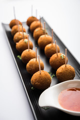 Crispy Veg lollipop recipe made using boiled potato with spices covered with corn flour and bread crumbs coating and then deep fried, served with toothpick or ice cream stock inserted in it with sauce