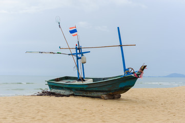 Naklejka na ściany i meble Fishing boat on a beach at ebb tide