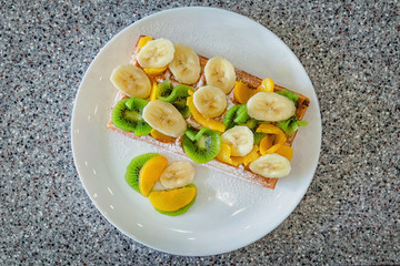 delicious Belgian waffles with fruit and ice cream