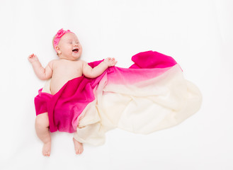 Top view of cute baby girl dressed in a fairy costume - fluttering long scarf and headband. Space for text