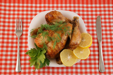 Grilled chicken in white plate on red tablecloth