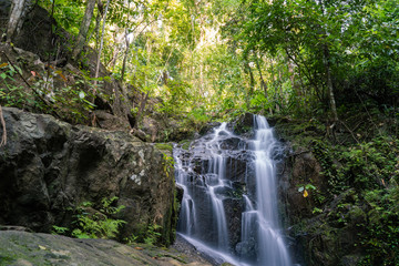 Fototapeta premium Ton Sai Waterfall in the tropical forest area In Asia, suitable for walks, nature walks and hiking, adventure photography Of the national park Phuket Thailand.