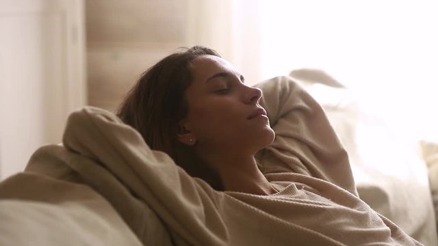 Calm young woman having healthy nap relax on couch