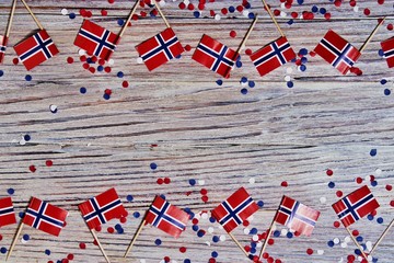 Norwegian independence day, Constitution day, may 17. holiday of freedom, victory and memory, day off. The concept of patriotism and faith. paper confetti and mini flags on wood