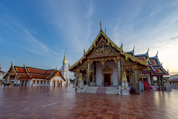 Naklejka premium Beautiful sunset in Wat Pratat Choeng Chum at Sakon Nakhon Province Thailand.Landmark of thailand