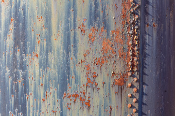 Background of rusted metal and corroded paint, rivets, horizontal aspect