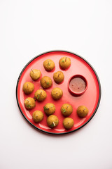 Crispy Veg lollipop recipe made using boiled potato with spices covered with corn flour and bread crumbs coating and then deep fried, served with toothpick or ice cream stock inserted in it with sauce