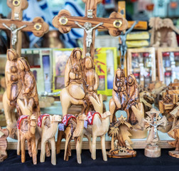 Naklejka premium Olive wood handmade christian symbolism sold at street market