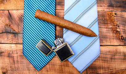 Fashion look. Business detail. male tie and cigar. Male shop. necktie for real men. Modern formal style. vintage. retro style. Cigar and lighter. Wedding elegant accessory. mens club