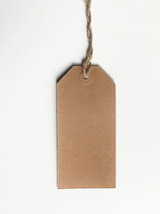 Blank tag tied with string. Price tag, gift tag, sale tag, address label