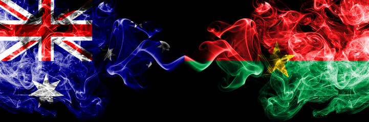 Australia vs Burkina Faso smoky mystic flags placed side by side. Thick colored silky smokes combination of national flags of Australia and Burkina Faso
