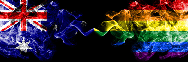 Australia vs Gay pride smoky mystic flags placed side by side. Thick colored silky smokes combination of national flags of Australia and Gay pride