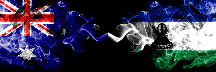 Australia vs Lesotho smoky mystic flags placed side by side. Thick colored silky smokes combination of national flags of Australia and Lesotho