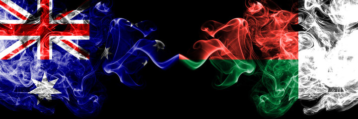 Australia vs Madagascar, Madagascan smoky mystic flags placed side by side. Thick colored silky smokes combination of national flags of Australia and Madagascar, Madagascan