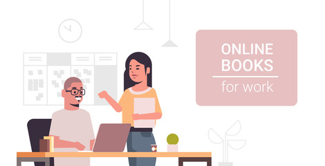 business colleagues using laptop at workplace desk couple reading online books for work concept modern office interior flat portrait horizontal