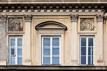 Fototapeta na wymiar Window decoration of buildings of Krakow suburb street.